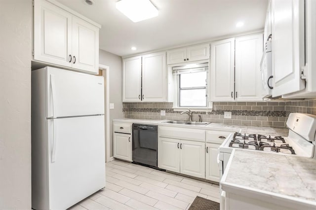 3020 NW 71st St, Oklahoma City, OK 73116 - kitchen with white appliances, decorative backsplash, light countertops, white cabinets, and recessed lighting