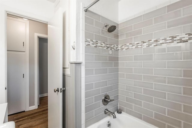 3020 NW 71st St, Oklahoma City, OK 73116 - bathroom featuring bathtub / shower combination and wood finished floors