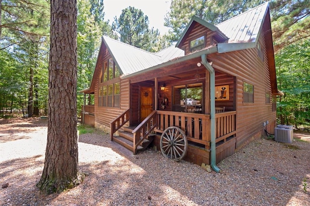 244 Hiddenwater Rd, Broken Bow, OK 74728 - view of front of house with covered porch, log veneer siding, and a metal roof