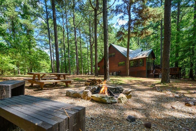 244 Hiddenwater Rd, Broken Bow, OK 74728 - view of yard featuring an outdoor fire pit and a wooden deck