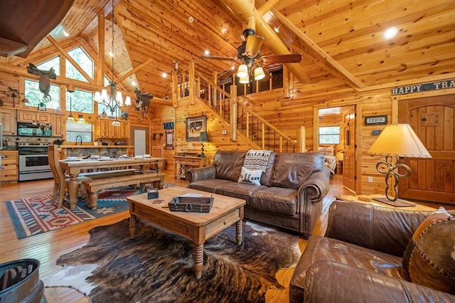 244 Hiddenwater Rd, Broken Bow, OK 74728 - living area featuring light wood-style floors, wood walls, plenty of natural light, ceiling fan, and a wooden ceiling with exposed beams