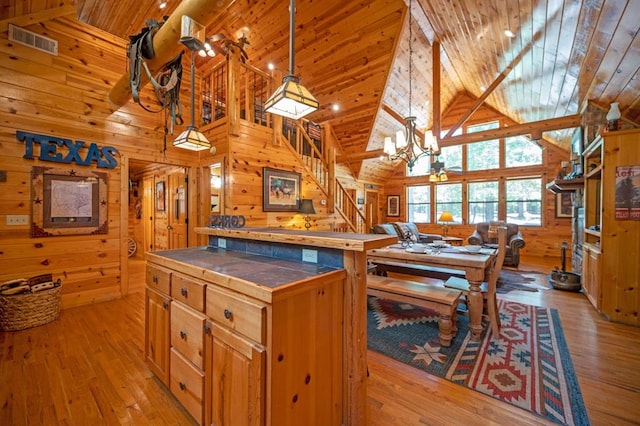 244 Hiddenwater Rd, Broken Bow, OK 74728 - kitchen featuring tile countertops, wood ceiling, wood walls, high vaulted ceiling, and light wood-type flooring
