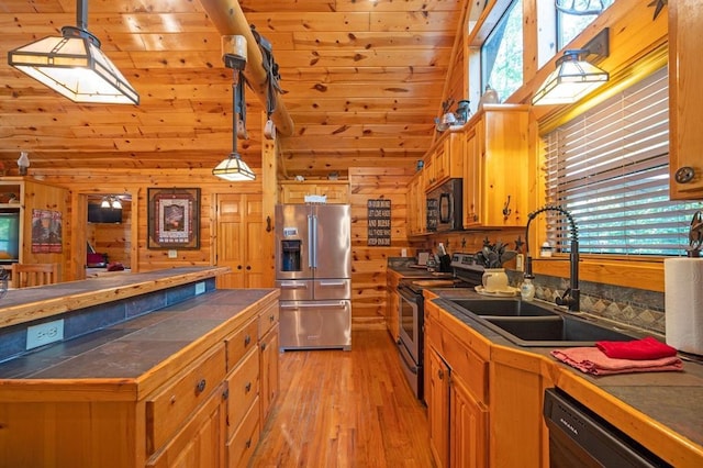 244 Hiddenwater Rd, Broken Bow, OK 74728 - kitchen featuring appliances with stainless steel finishes, tile counters, light wood-style floors, high vaulted ceiling, and wood walls