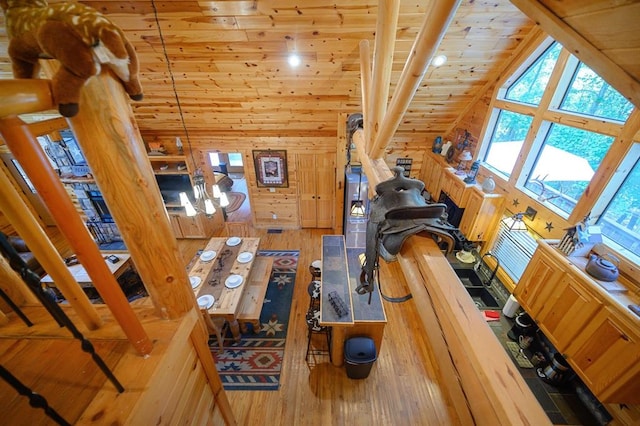 244 Hiddenwater Rd, Broken Bow, OK 74728 - living room with high vaulted ceiling, wood-type flooring, wood ceiling, and wood walls