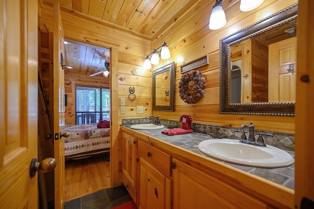 244 Hiddenwater Rd, Broken Bow, OK 74728 - bathroom with double vanity, wooden walls, wooden ceiling, and connected bathroom