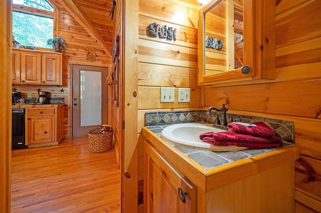 244 Hiddenwater Rd, Broken Bow, OK 74728 - bathroom with wooden walls, vanity, wood finished floors, and vaulted ceiling