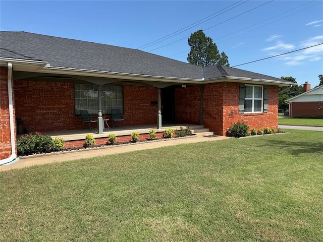 1901 N Oklahoma Ave, Shawnee, OK 74804 - single story home with brick siding, covered porch, a front yard, and a shingled roof