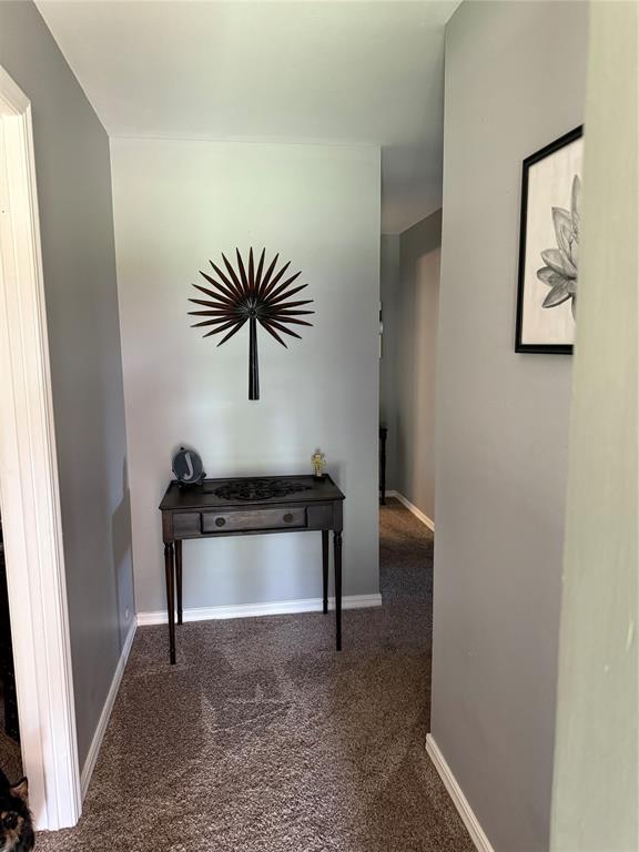 1901 N Oklahoma Ave, Shawnee, OK 74804 - hallway with carpet floors and baseboards
