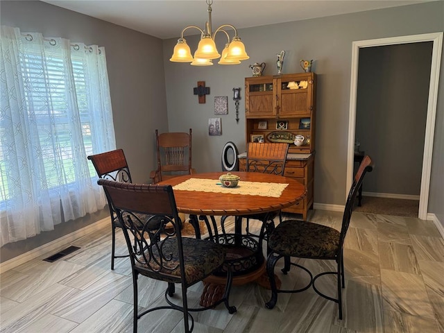 1901 N Oklahoma Ave, Shawnee, OK 74804 - dining space featuring a chandelier and baseboards