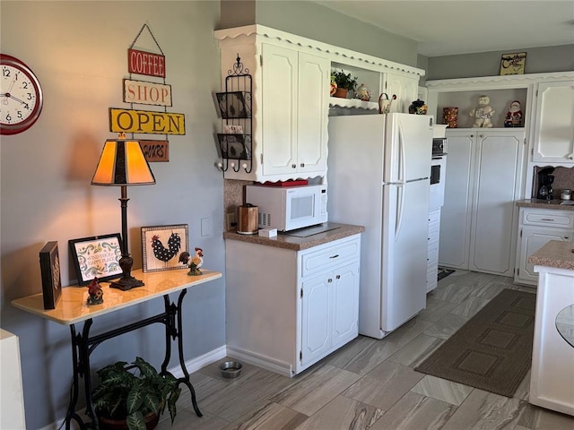 1901 N Oklahoma Ave, Shawnee, OK 74804 - kitchen featuring open shelves, white appliances, and white cabinets