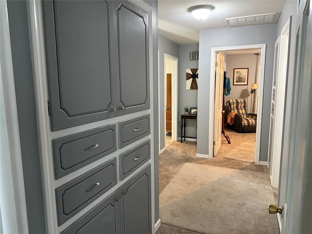 1901 N Oklahoma Ave, Shawnee, OK 74804 - hallway featuring light colored carpet and baseboards