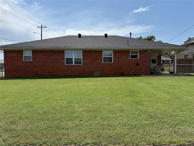 1901 N Oklahoma Ave, Shawnee, OK 74804 - back of property with crawl space, brick siding, a patio area, and roof with shingles