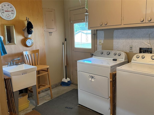 1901 N Oklahoma Ave, Shawnee, OK 74804 - laundry room with washing machine and clothes dryer, cabinet space, wood walls, and electric panel