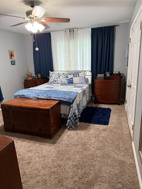 1901 N Oklahoma Ave, Shawnee, OK 74804 - carpeted bedroom with a ceiling fan