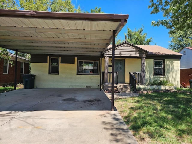 4001 SE 22nd St, Del City, OK 73115 - view of front of house featuring brick siding, an attached carport, a front yard, and concrete driveway
