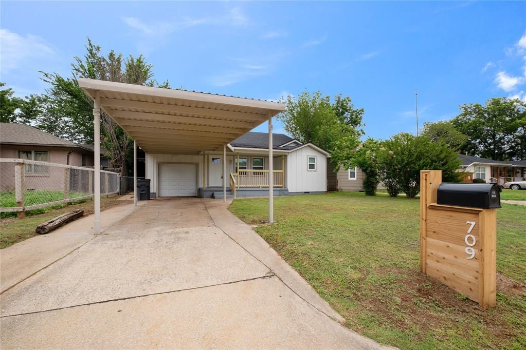 709 SW Jefferson Ave, Lawton, OK 73501 - view of front of home featuring a carport, driveway, and covered porch