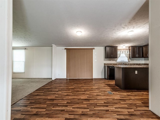 355370 E 970th Rd, Sparks, OK 74869 - kitchen with dark brown cabinets, a textured ceiling, dark wood-style floors, open floor plan, and black dishwasher