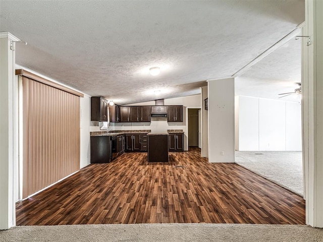 355370 E 970th Rd, Sparks, OK 74869 - kitchen with open floor plan, dark brown cabinets, a kitchen island, dark wood-type flooring, and a textured ceiling