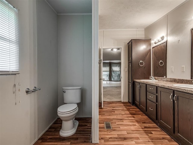 355370 E 970th Rd, Sparks, OK 74869 - bathroom with wood finished floors, double vanity, and ornamental molding