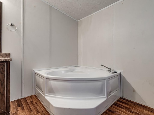 355370 E 970th Rd, Sparks, OK 74869 - full bathroom featuring a textured ceiling, a bath, and wood finished floors