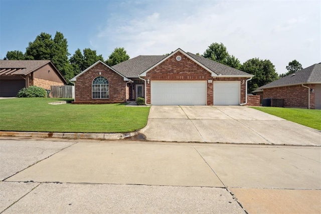 12417 Sussex Dr, Oklahoma City, OK 73130 - view of front of property featuring brick siding, a front yard, an attached garage, and driveway