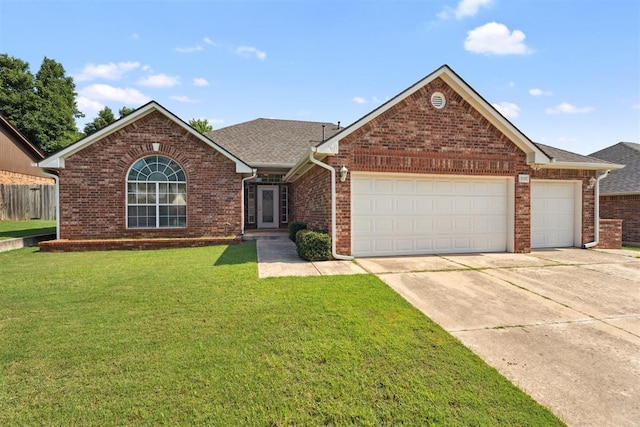 12417 Sussex Dr, Oklahoma City, OK 73130 - view of front of home with an attached garage, driveway, brick siding, and a front yard