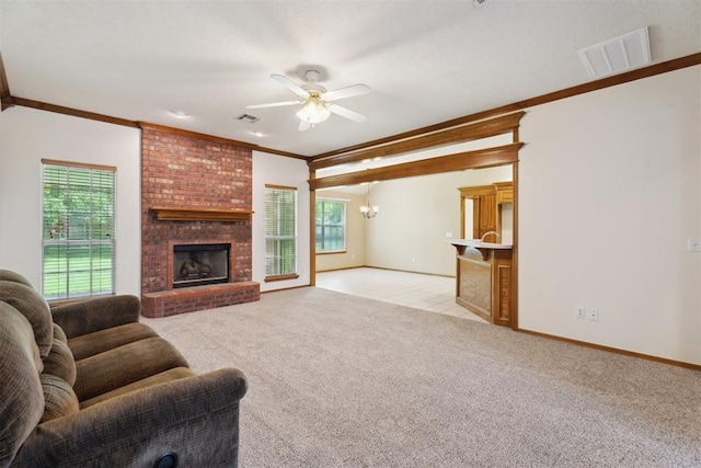 12417 Sussex Dr, Oklahoma City, OK 73130 - living room featuring ornamental molding, plenty of natural light, a ceiling fan, light colored carpet, and a fireplace