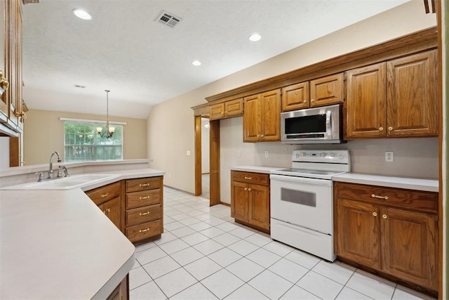 12417 Sussex Dr, Oklahoma City, OK 73130 - kitchen featuring stainless steel microwave, white range with electric stovetop, brown cabinets, light countertops, and recessed lighting