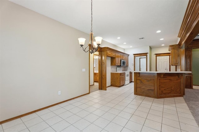 12417 Sussex Dr, Oklahoma City, OK 73130 - kitchen with white electric range, light countertops, a chandelier, recessed lighting, and a kitchen bar