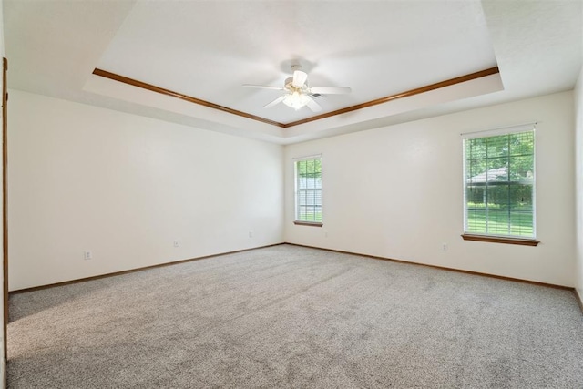 12417 Sussex Dr, Oklahoma City, OK 73130 - carpeted empty room featuring a raised ceiling, a ceiling fan, and crown molding