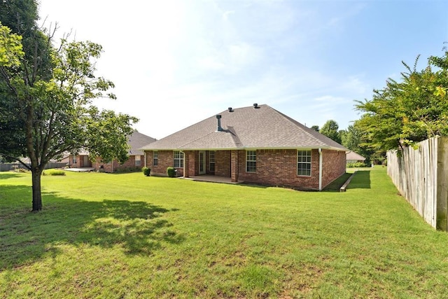 12417 Sussex Dr, Oklahoma City, OK 73130 - rear view of house featuring brick siding, a patio, and a shingled roof