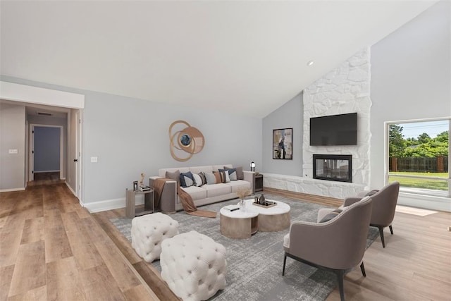 2104 Brookhaven Dr, Edmond, OK 73034 - living room with light wood finished floors, high vaulted ceiling, and a fireplace