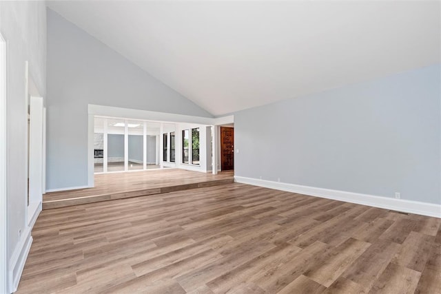 2104 Brookhaven Dr, Edmond, OK 73034 - unfurnished living room featuring high vaulted ceiling and light wood-style floors