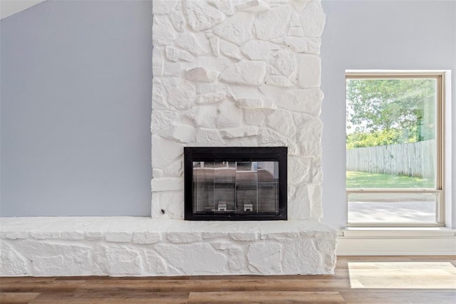 2104 Brookhaven Dr, Edmond, OK 73034 - detailed view of a stone fireplace and wood finished floors