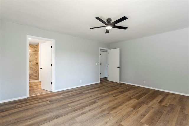 2104 Brookhaven Dr, Edmond, OK 73034 - unfurnished bedroom with wood finished floors, connected bathroom, and a ceiling fan