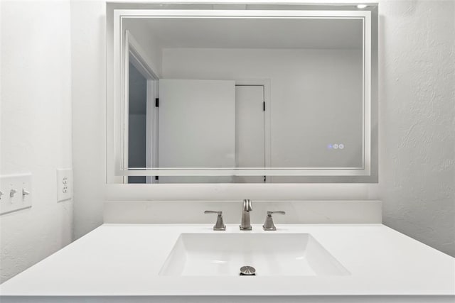 2104 Brookhaven Dr, Edmond, OK 73034 - bathroom featuring vanity and a textured wall