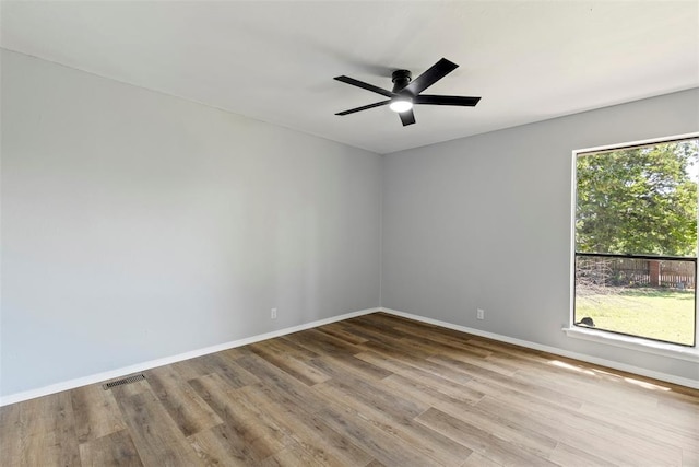 2104 Brookhaven Dr, Edmond, OK 73034 - spare room with wood finished floors and ceiling fan