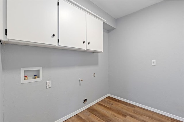 2104 Brookhaven Dr, Edmond, OK 73034 - washroom with cabinet space, light wood-type flooring, and washer hookup