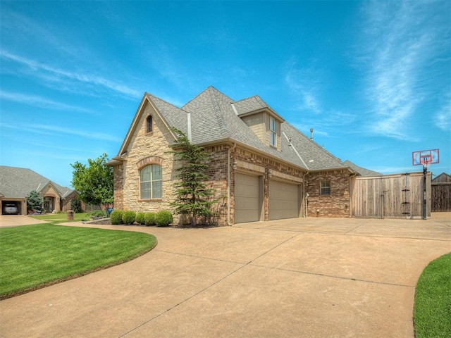 16208 Windrush Pl, Edmond, OK 73013 - view of property exterior featuring concrete driveway, brick siding, roof with shingles, an attached garage, and stone siding