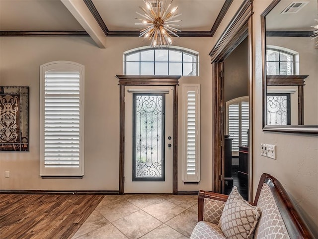 16208 Windrush Pl, Edmond, OK 73013 - entryway with a chandelier, ornamental molding, and beamed ceiling