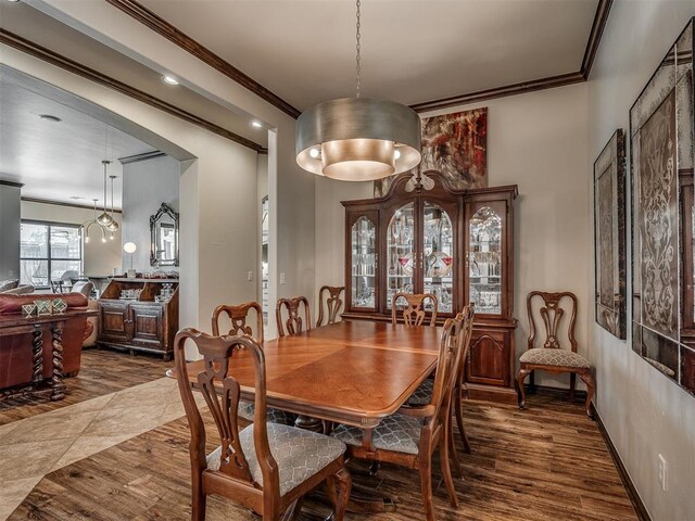16208 Windrush Pl, Edmond, OK 73013 - dining area with crown molding and dark wood-type flooring