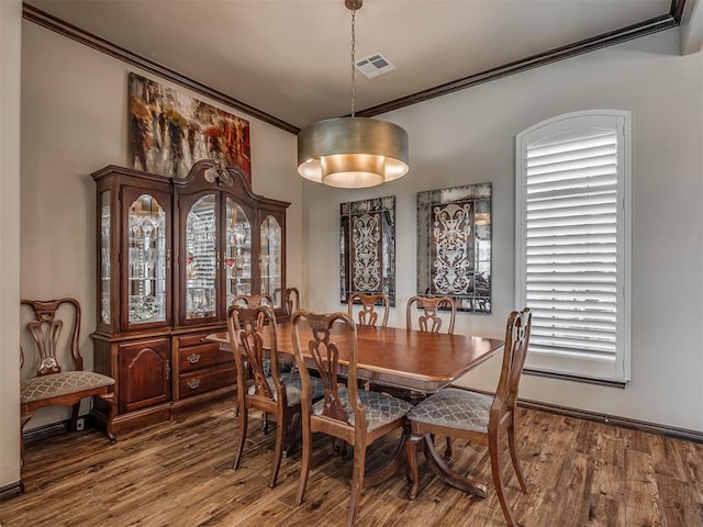 16208 Windrush Pl, Edmond, OK 73013 - dining space with ornamental molding and wood finished floors