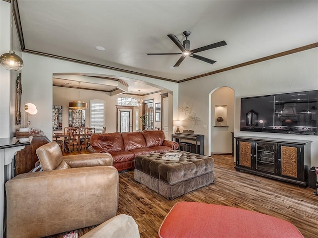 16208 Windrush Pl, Edmond, OK 73013 - living area with arched walkways, crown molding, ceiling fan, and wood finished floors