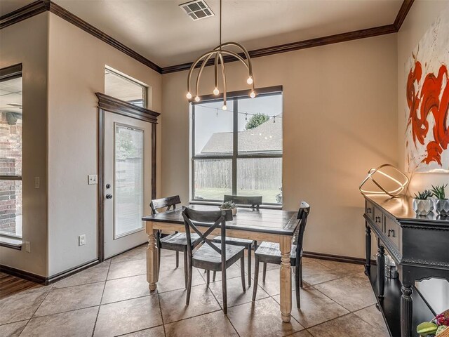 16208 Windrush Pl, Edmond, OK 73013 - dining space featuring plenty of natural light, ornamental molding, light tile patterned flooring, and a chandelier