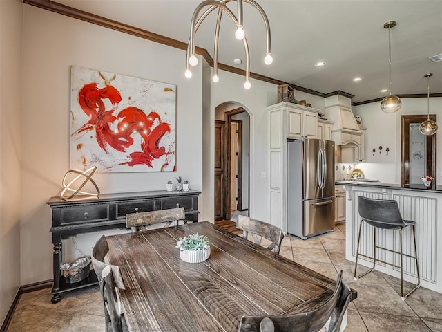 16208 Windrush Pl, Edmond, OK 73013 - dining area featuring arched walkways and ornamental molding