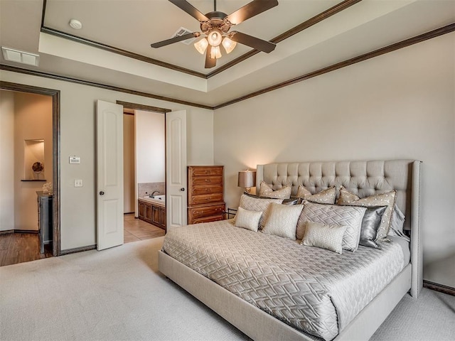 16208 Windrush Pl, Edmond, OK 73013 - bedroom featuring light carpet, crown molding, a raised ceiling, ensuite bath, and a ceiling fan
