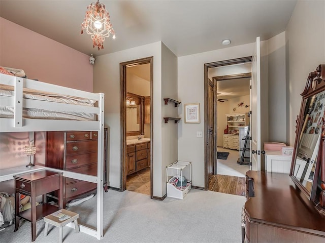 16208 Windrush Pl, Edmond, OK 73013 - bedroom with carpet, a chandelier, and connected bathroom