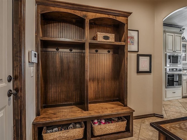 16208 Windrush Pl, Edmond, OK 73013 - mudroom featuring arched walkways and light tile patterned flooring