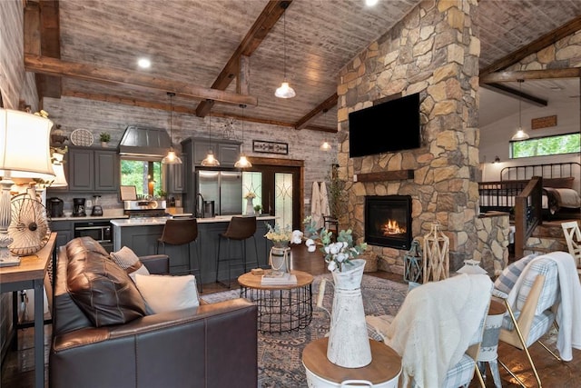 180 Black Jack Trl, Hochatown, OK 74728 - living room with high vaulted ceiling, a fireplace, and a wooden ceiling with exposed beams