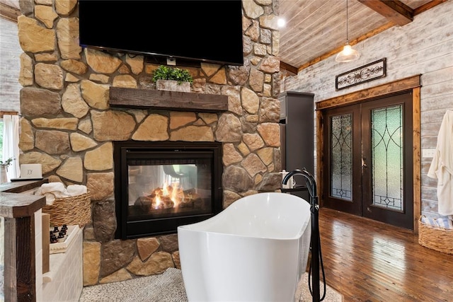 180 Black Jack Trl, Hochatown, OK 74728 - living area with wood-type flooring, a wood ceiling with exposed beams, and a stone fireplace